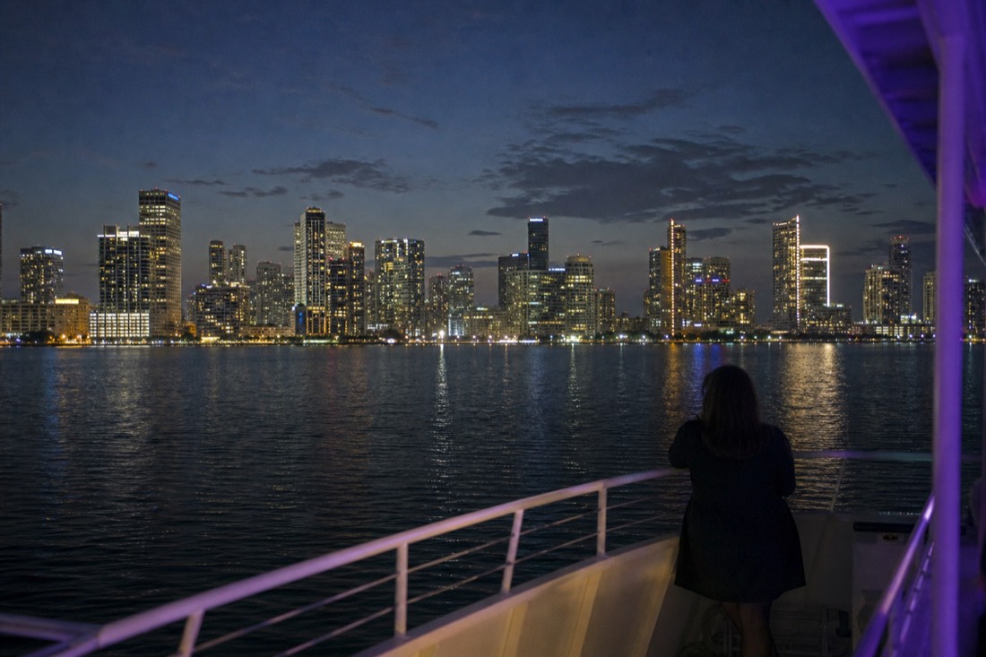 Fireworks bursting over Biscayne Bay with the illuminated Miami skyline in the background, no text, no logos, no people.