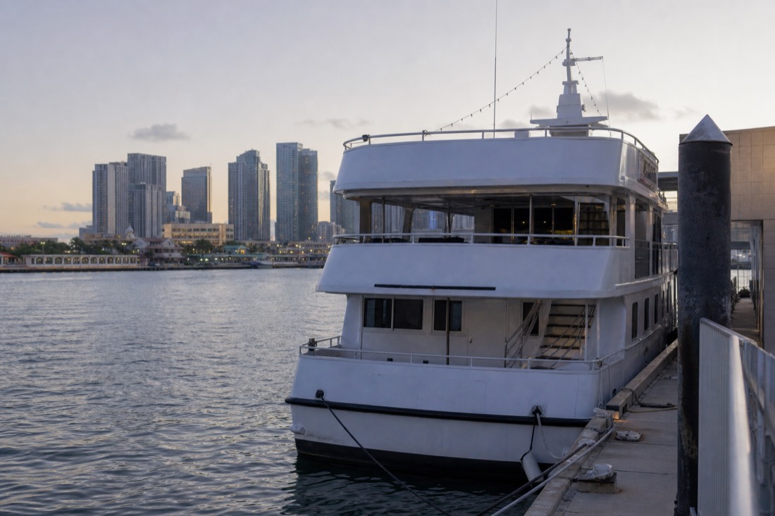 Golden hour over Bayfront Park with the downtown Miami skyline and Biscayne Bay in the background, no text, no logos, no people