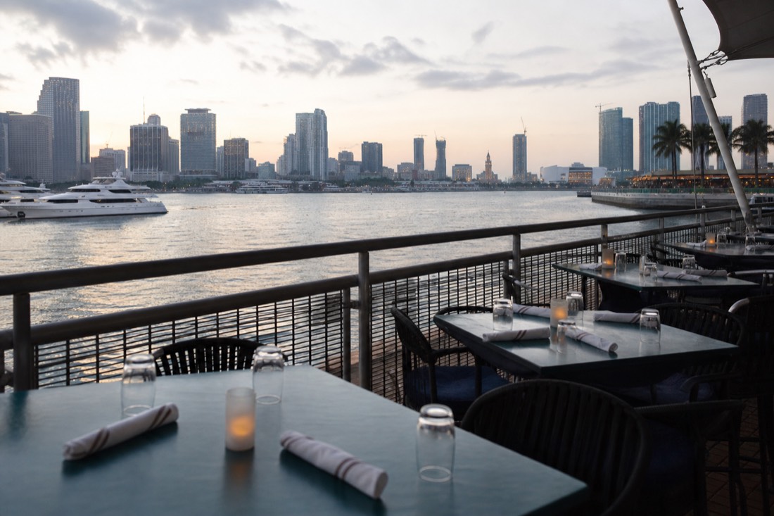 A catamaran cruise passing the downtown Miami skyline at golden hour, no text, no logos, no people