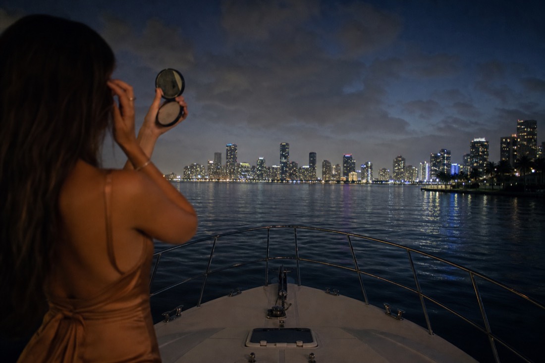 Passenger checking a mirror in evening attire before a cruise dinner, no text, no logos, no people
