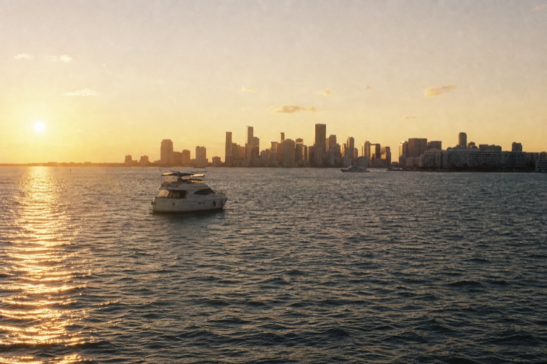 Golden hour light on Biscayne Bay with the Miami skyline in the background, no text, no logos, no people.